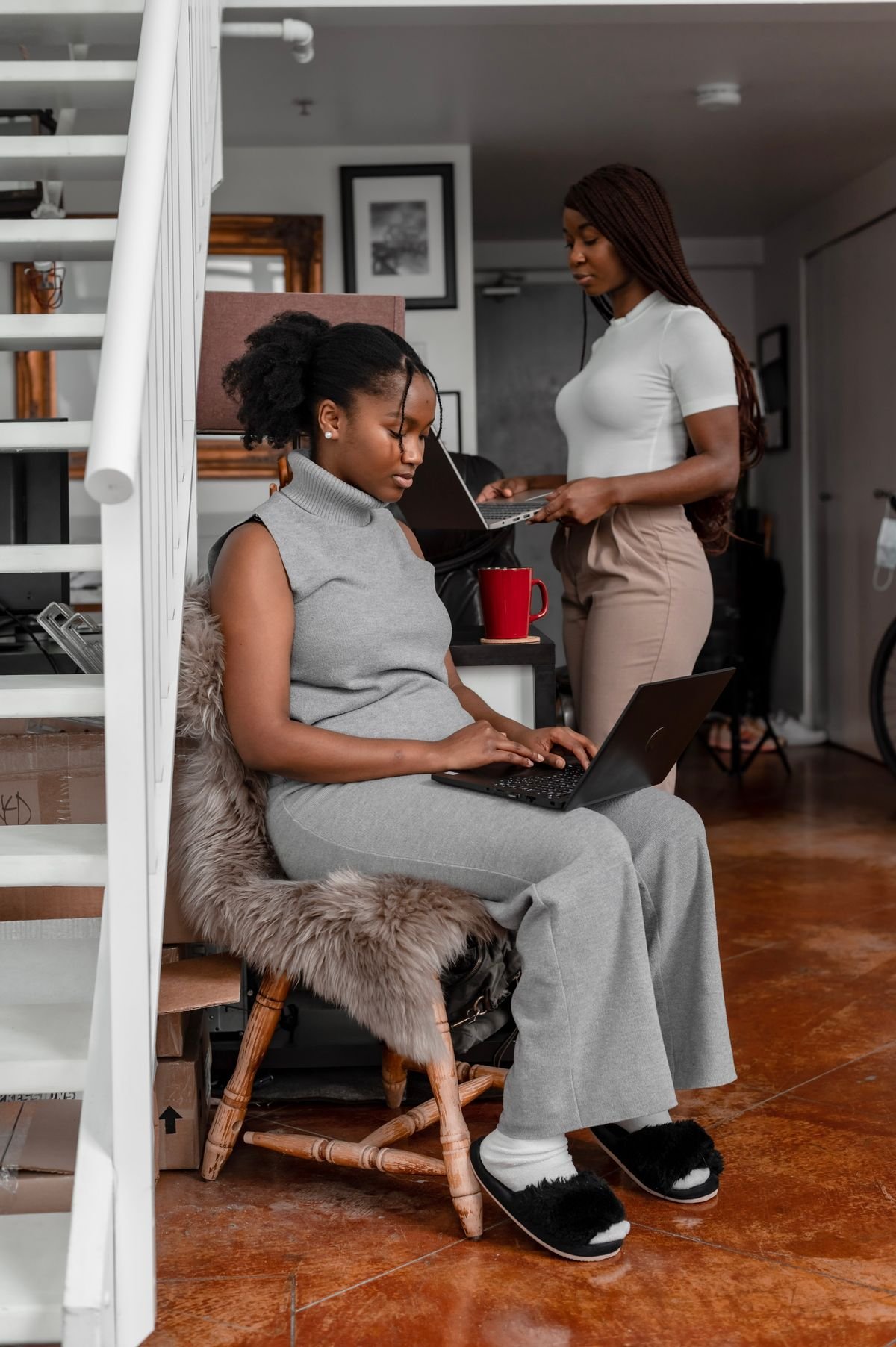 Two young marketers working on laptops